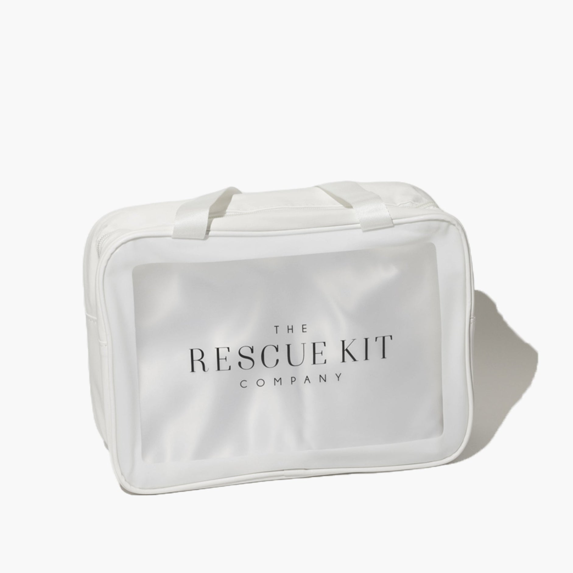 The Rescue Kit Company Photo Shoot Kit, shown in a clear, white zippered bag with branded tag and top handles—designed for on-set fashion emergencies.