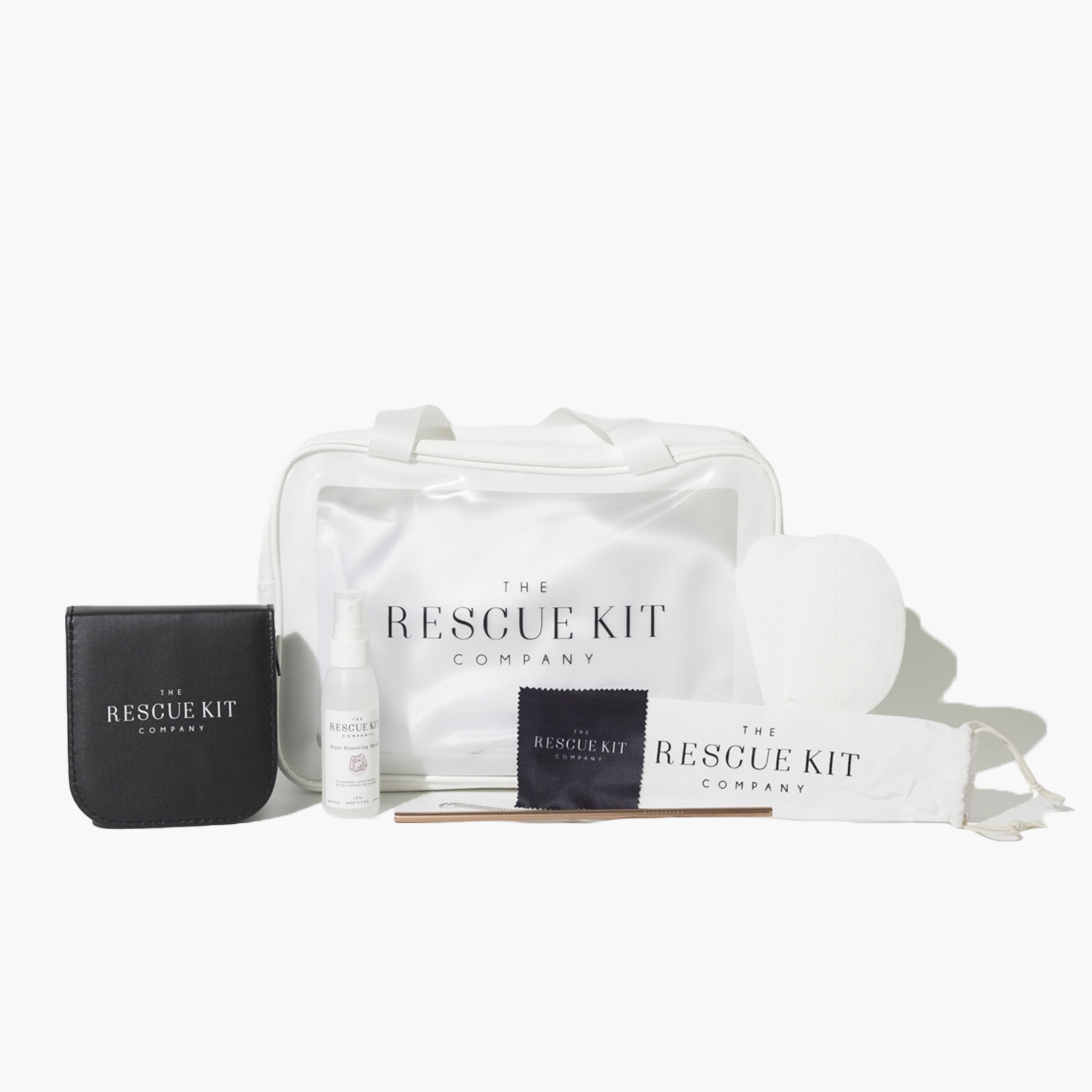 The Rescue Kit Company's Photo Shoot Kit, featuring a white cosmetic bag, stain removing spray, black leather sewing kit, underarm sweat pads, and reusable metal straw with cleaning brush in branded pouch.