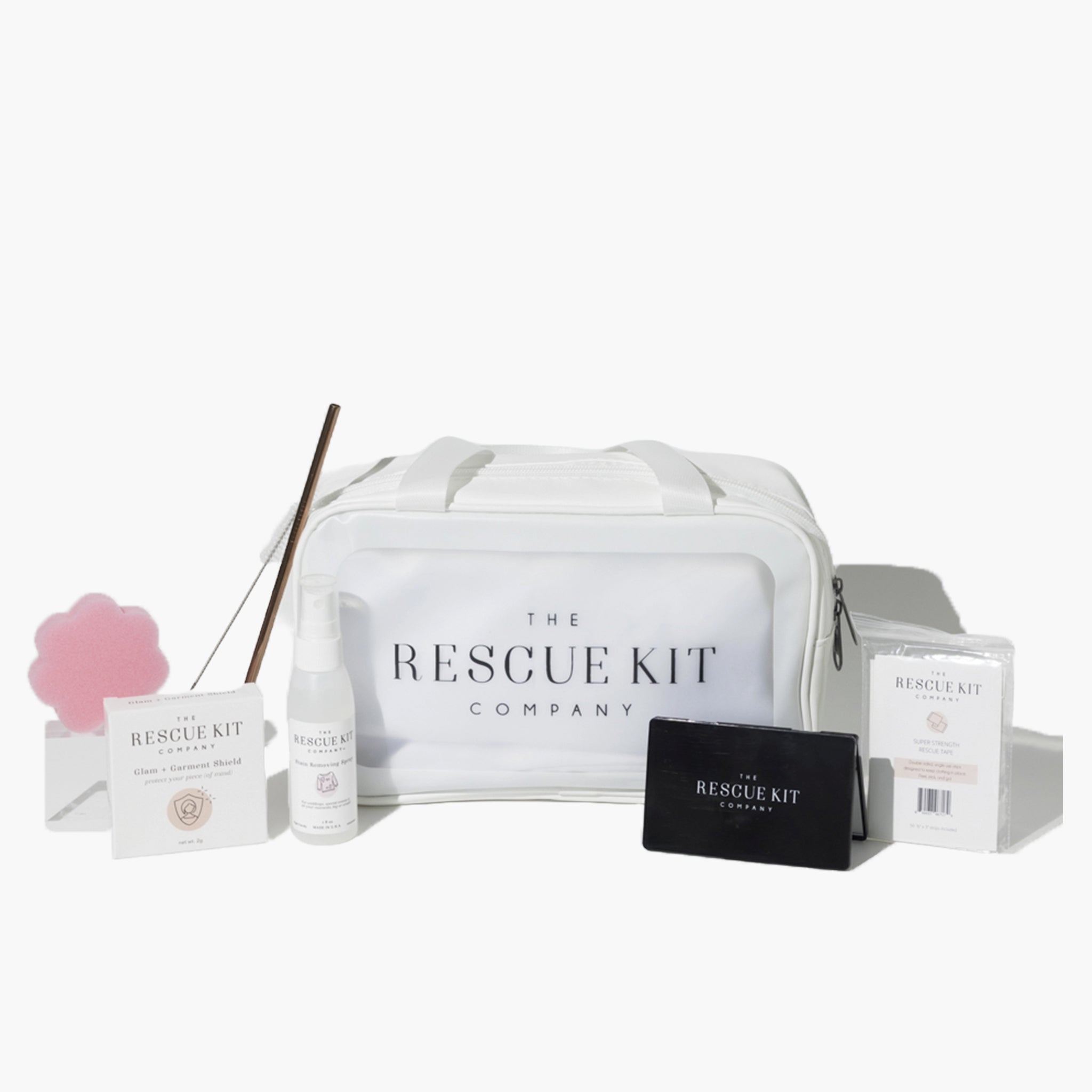The Classic Bride Kit by The Rescue Kit Company, featuring a medium white cosmetic bag, stain removing spray, deodorant sponge, glam + garment shield, mini tissues, reusable straw, and black compact mirror.