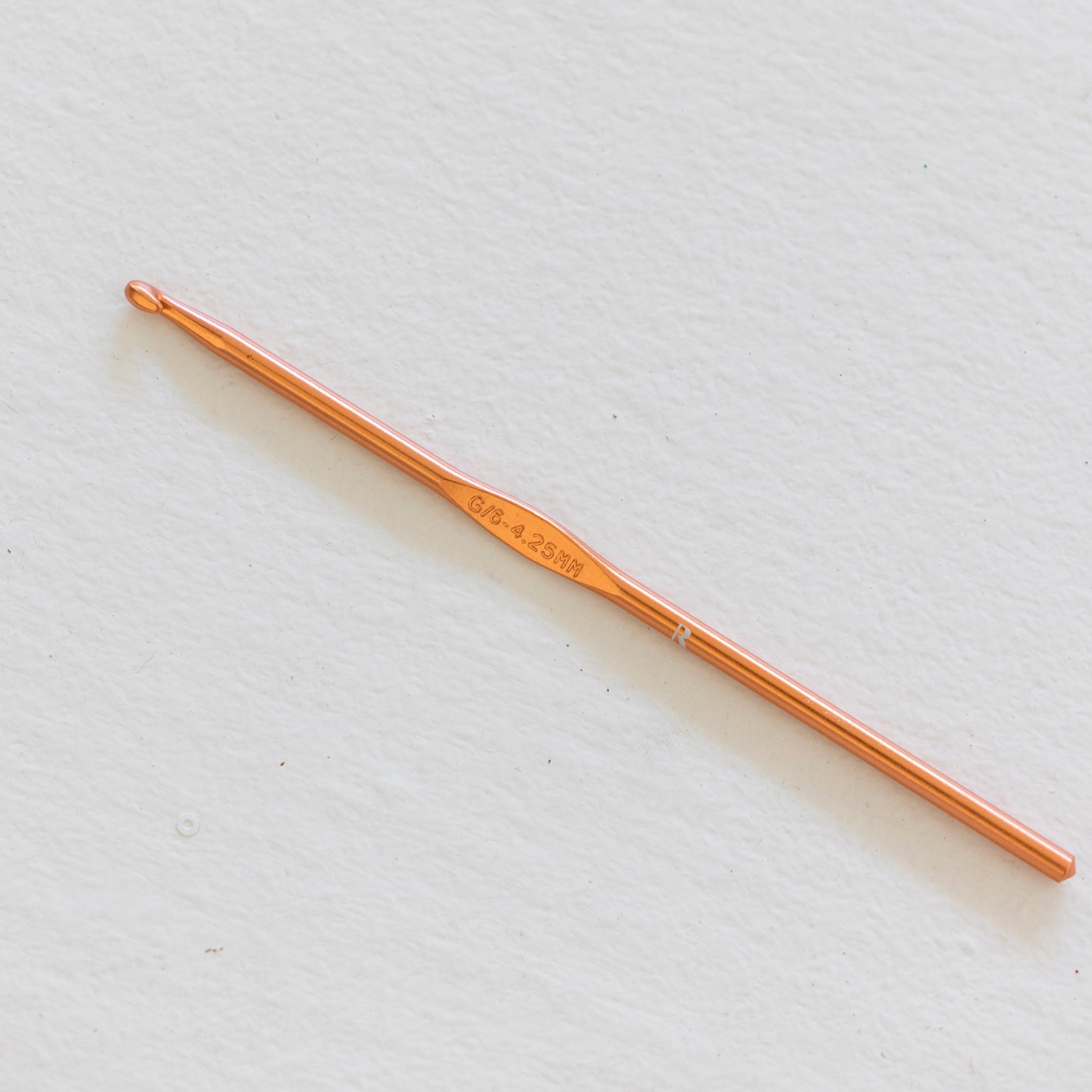 The Button and Bustle Hook by The Rescue Kit Company, a rose gold button and bustle hook designed to help brides secure their wedding gowns with ease.