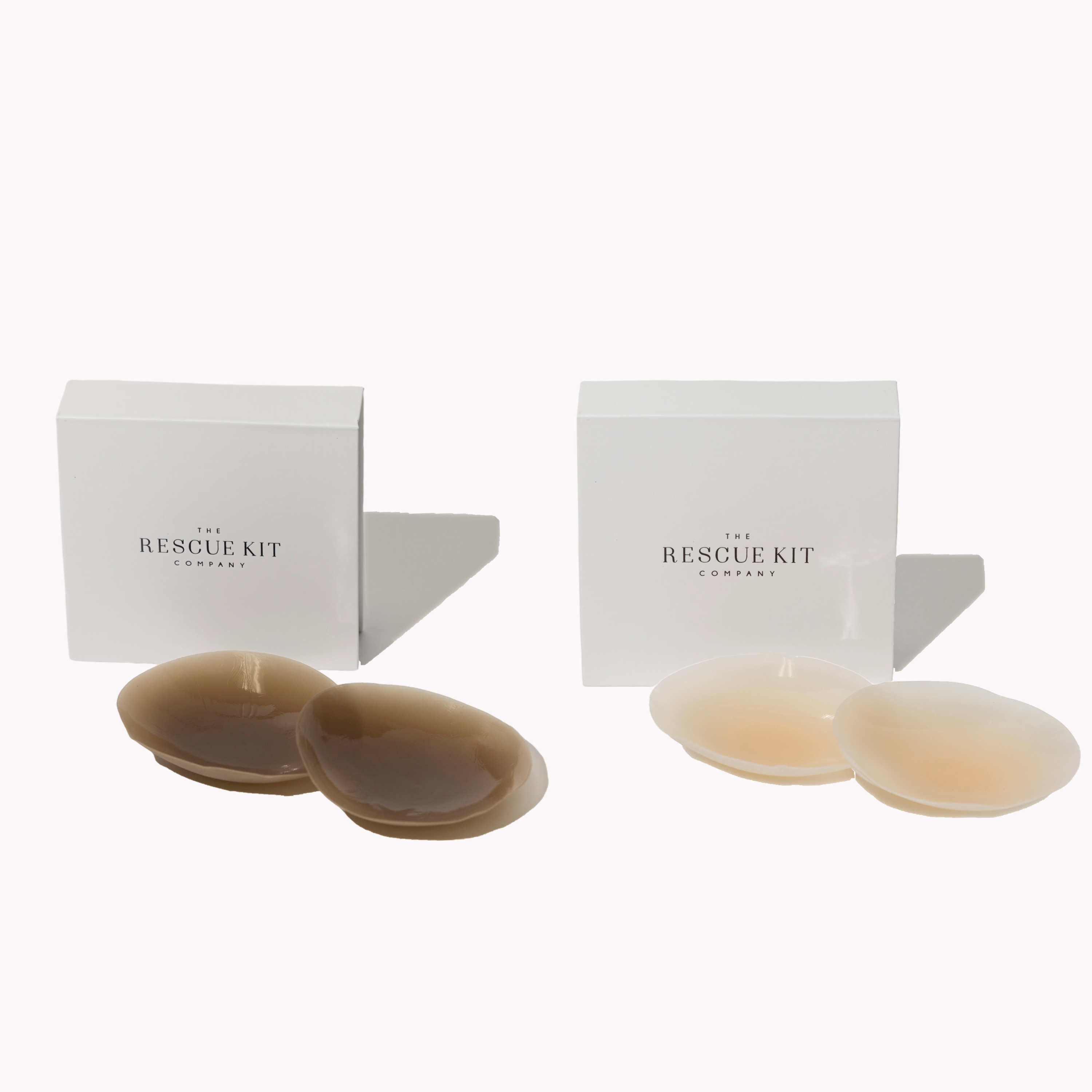 Two boxes labeled 'The Rescue Kit' with beige and brown pasties on a white background