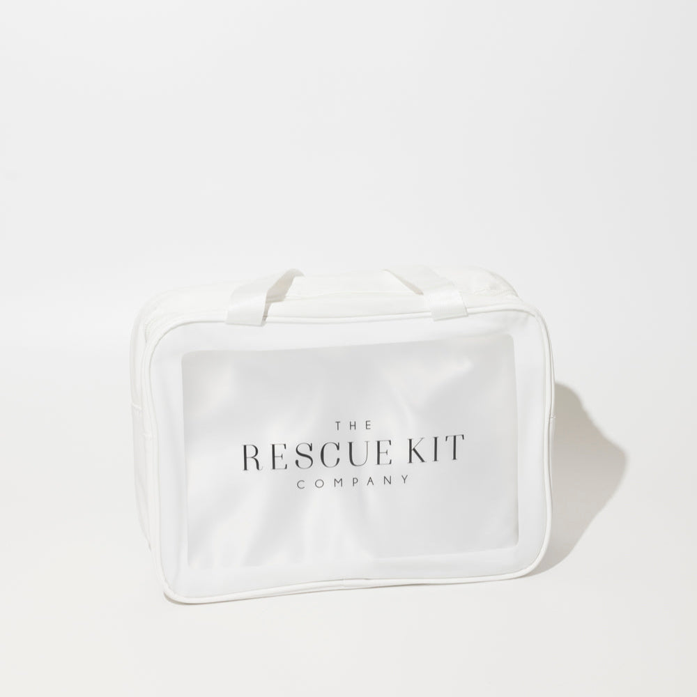 The Rescue Kit Company Photo Shoot Kit, shown in a clear, white zippered bag with branded tag and top handles—designed for on-set fashion emergencies.