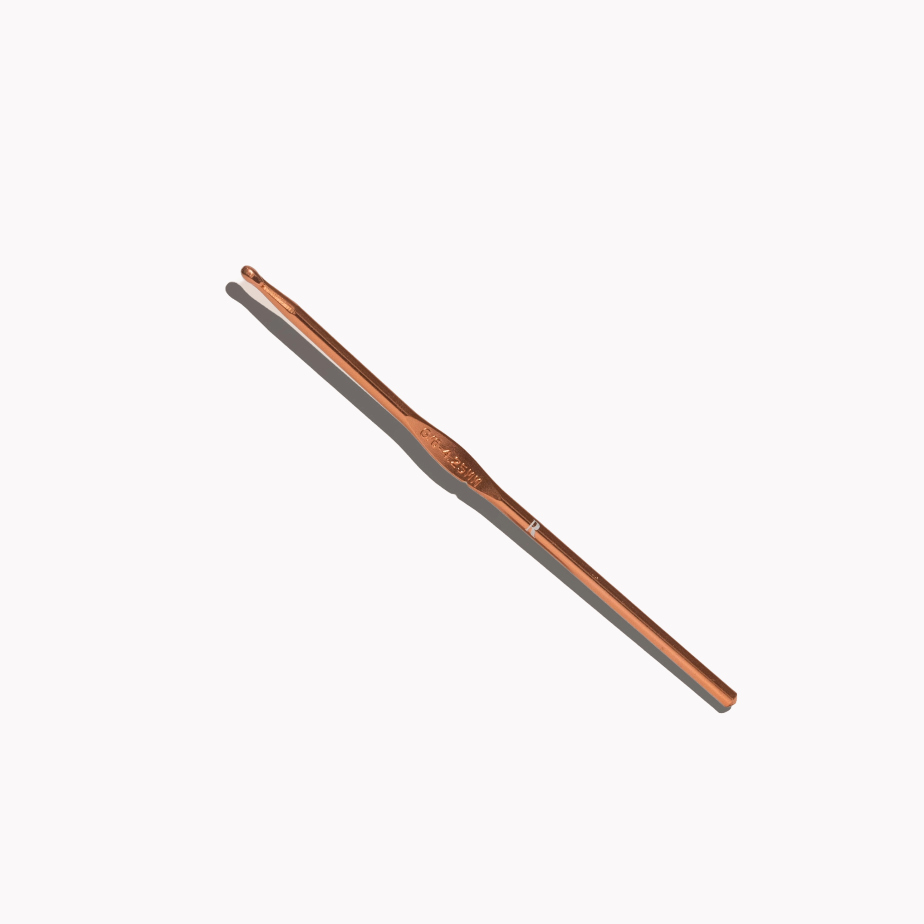 Rose gold Button + Bustle Hook on a white background