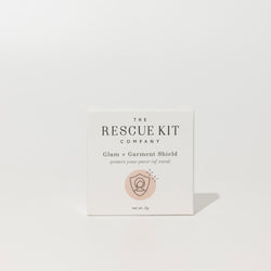 Exterior box of the Glam + Garment Shield by The Rescue Kit Company. White box, pink icon.