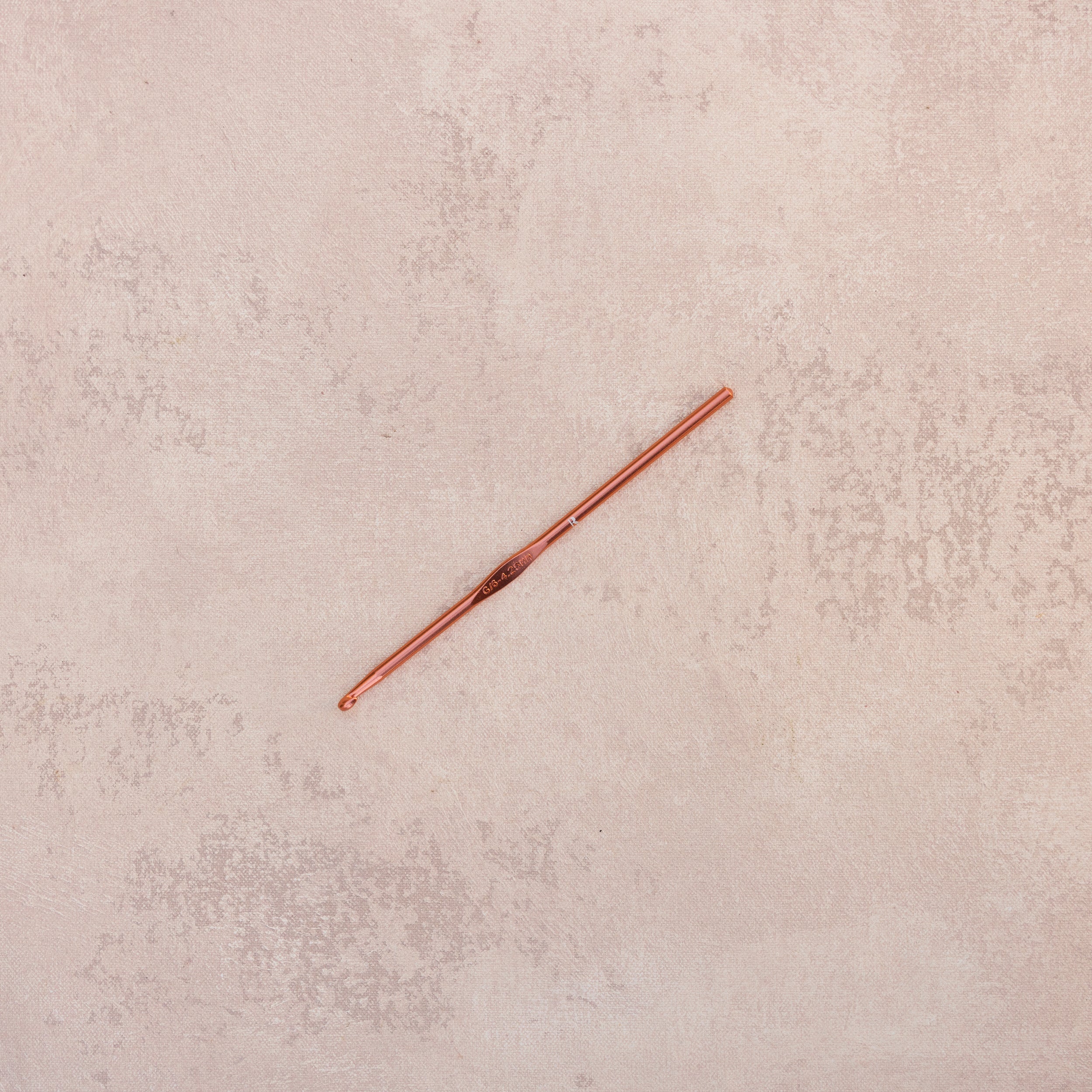 The Button and Bustle Hook by The Rescue Kit Company, a rose gold button and bustle hook designed to help brides secure their wedding gowns with ease.