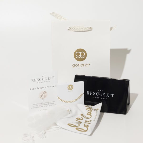 The Accessory Trio by The Rescue Kit Company. Black compact mirror, gold necklace extender by Gorjana, and Lobe Support Patches.