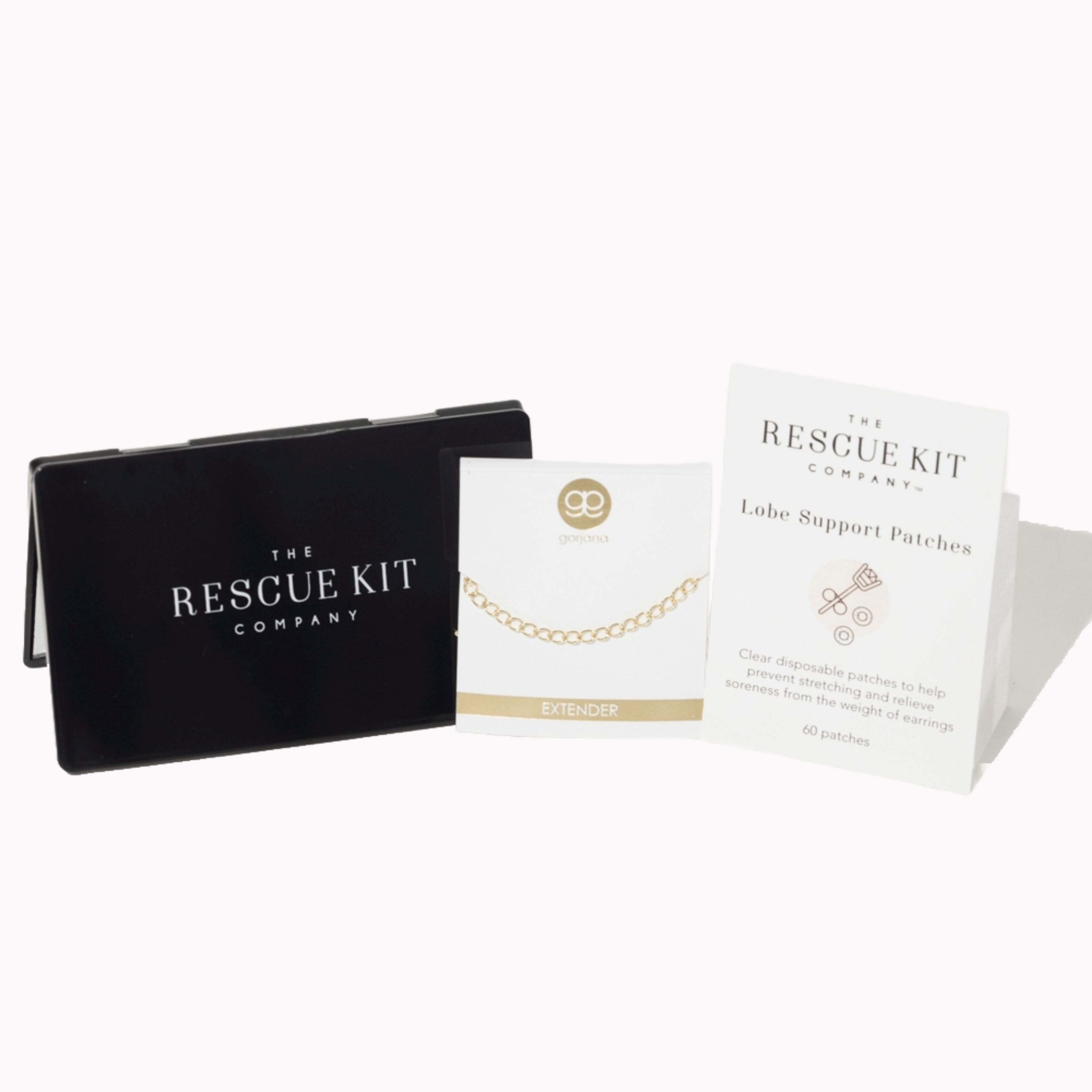 The Accessory Trio by The Rescue Kit Company. Black compact mirror, gold necklace extender by Gorjana, and Lobe Support Patches.