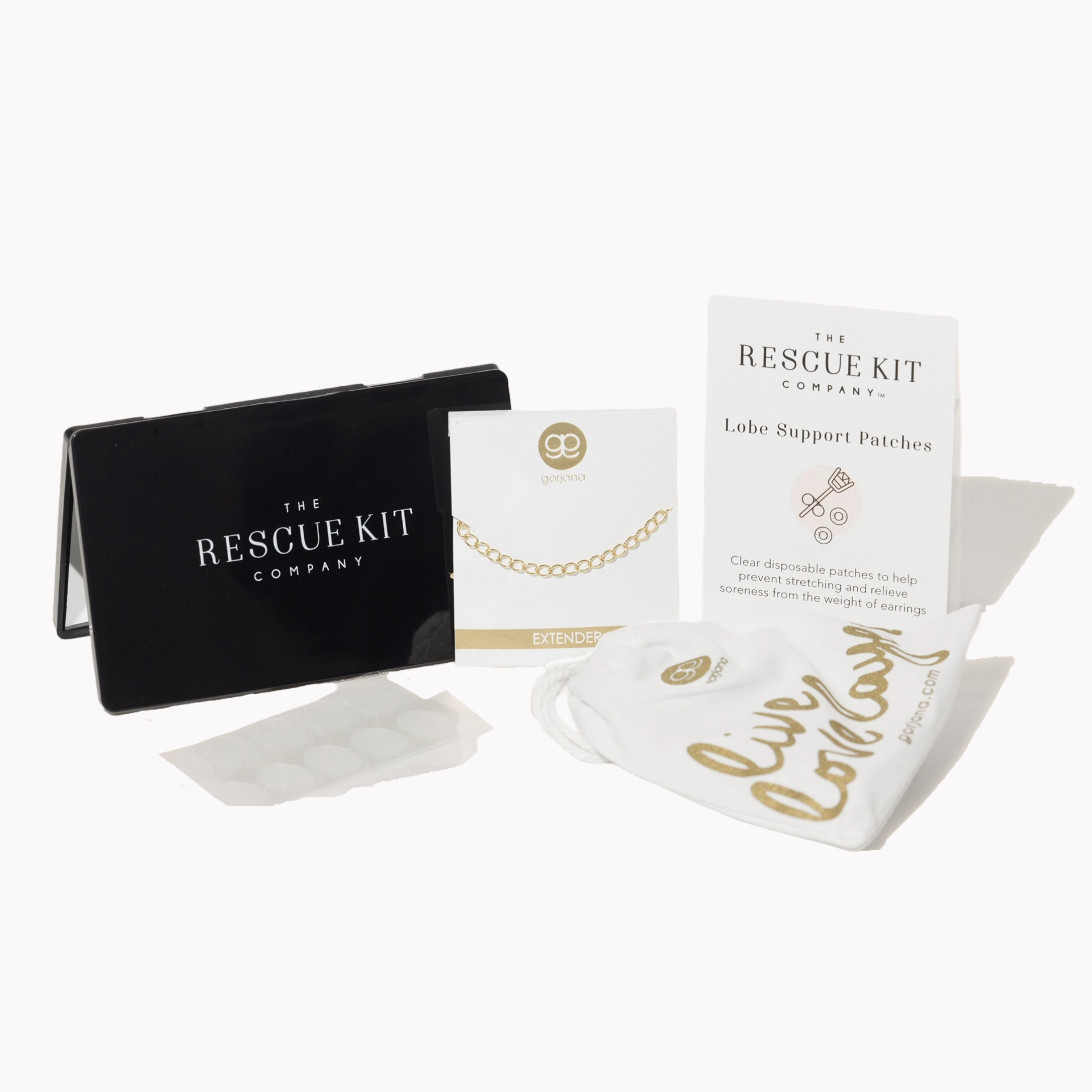 The Accessory Trio by The Rescue Kit Company. Black compact mirror, gold necklace extender by Gorjana, and Lobe Support Patches.