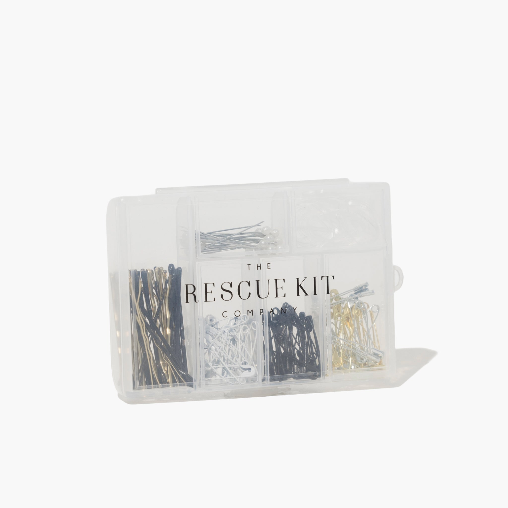 Clear plastic container with hair pins labeled 'The Rescue Kit Company' on a white background