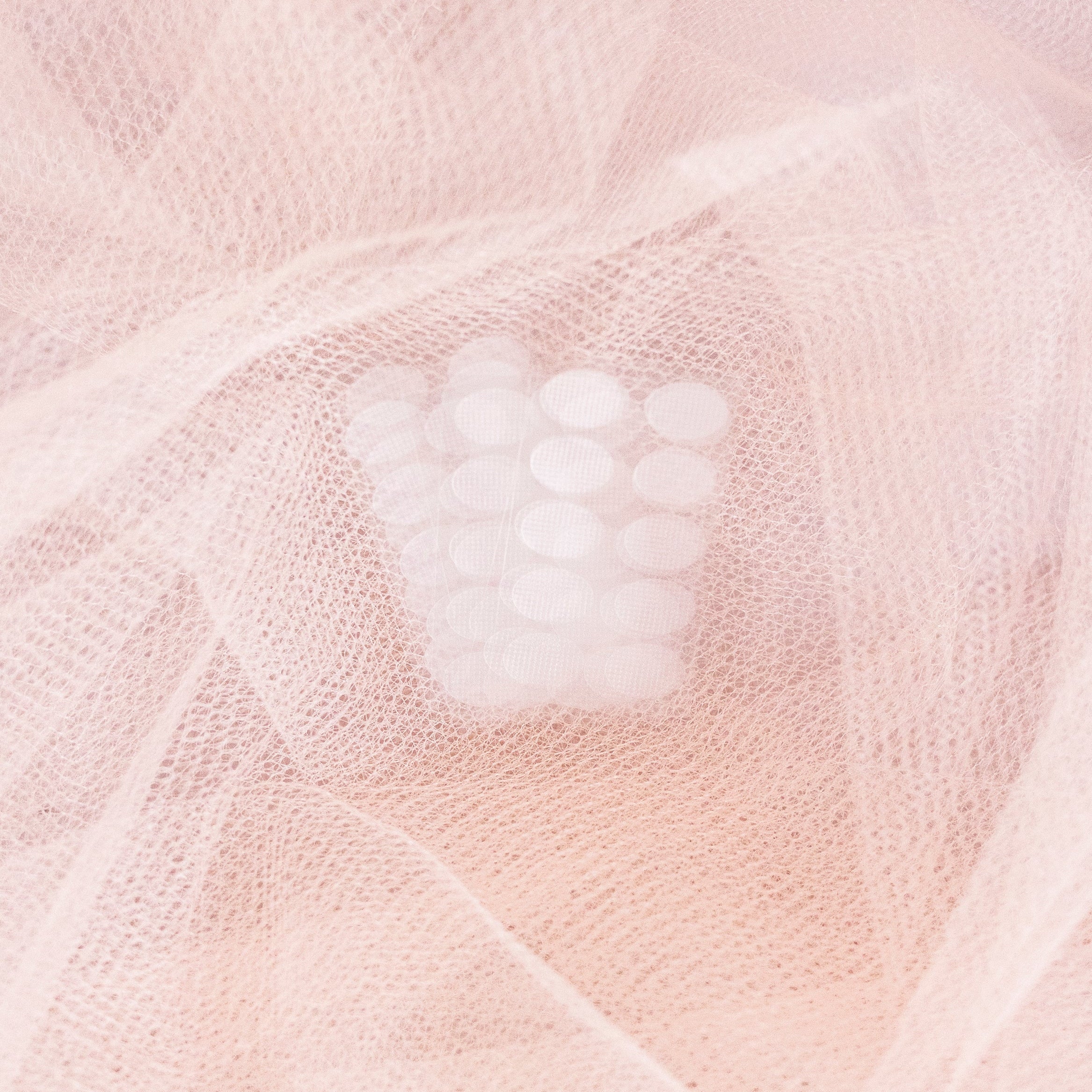 Close-up of a textured pink fabric with lobe support patches on top.