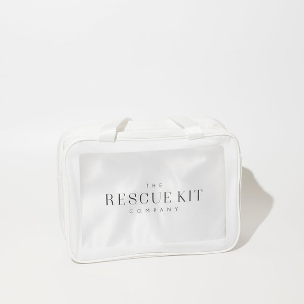 The Rescue Kit Company Photo Shoot Kit, shown in a clear, white zippered bag with branded tag and top handles—designed for on-set fashion emergencies.