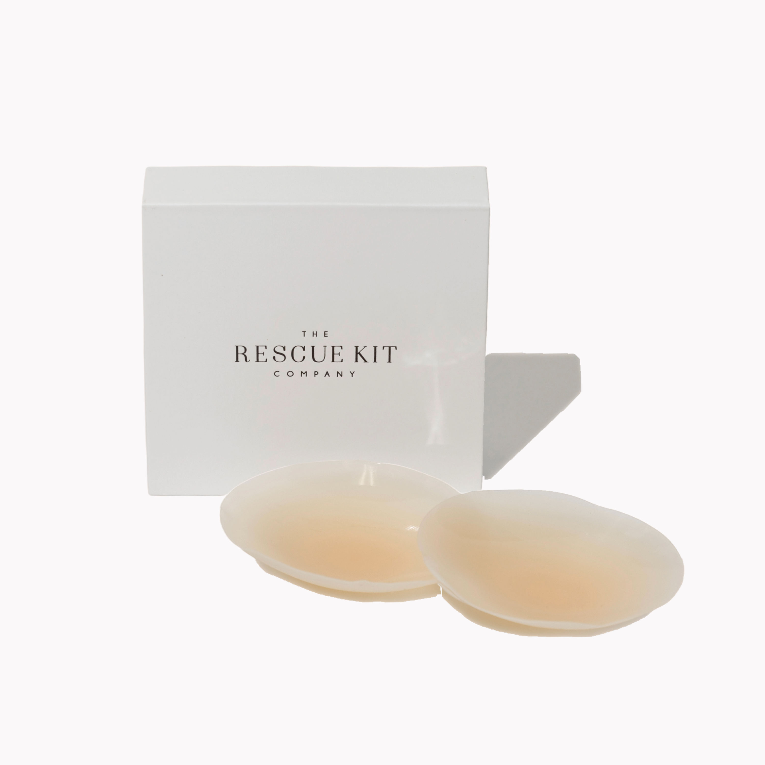 Two beige pasties in front of a white box with 'The Rescue Kit Company' branding on a white background.