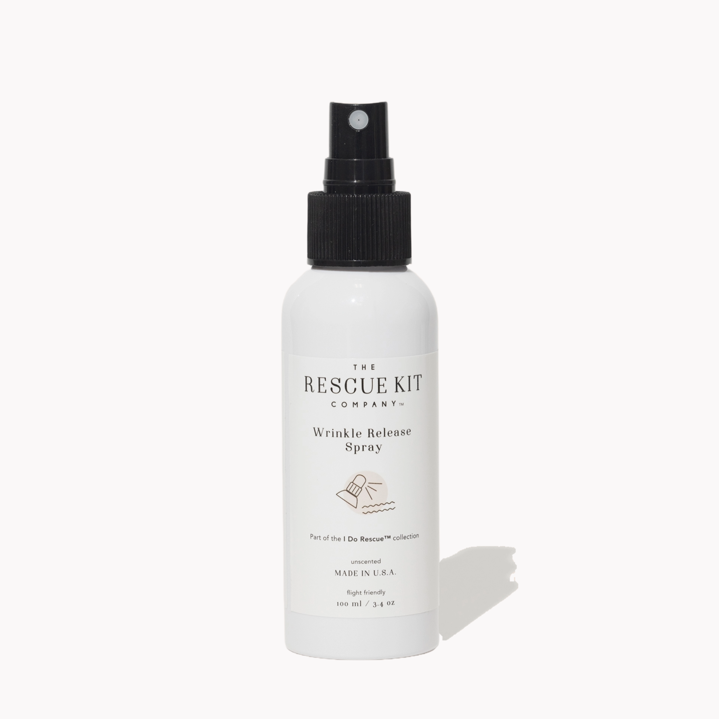 White wrinkle release spray bottle with black nozzle labeled 'The Rescue Kit Company' on a white background